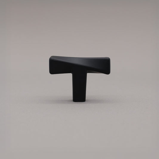 Satin Brass twist Knob on a gray background.