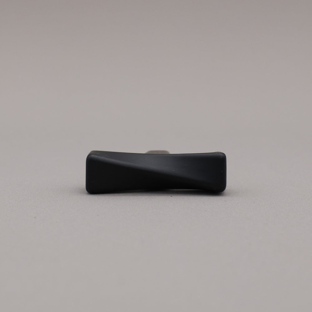 Black twisted knob on a gray background
