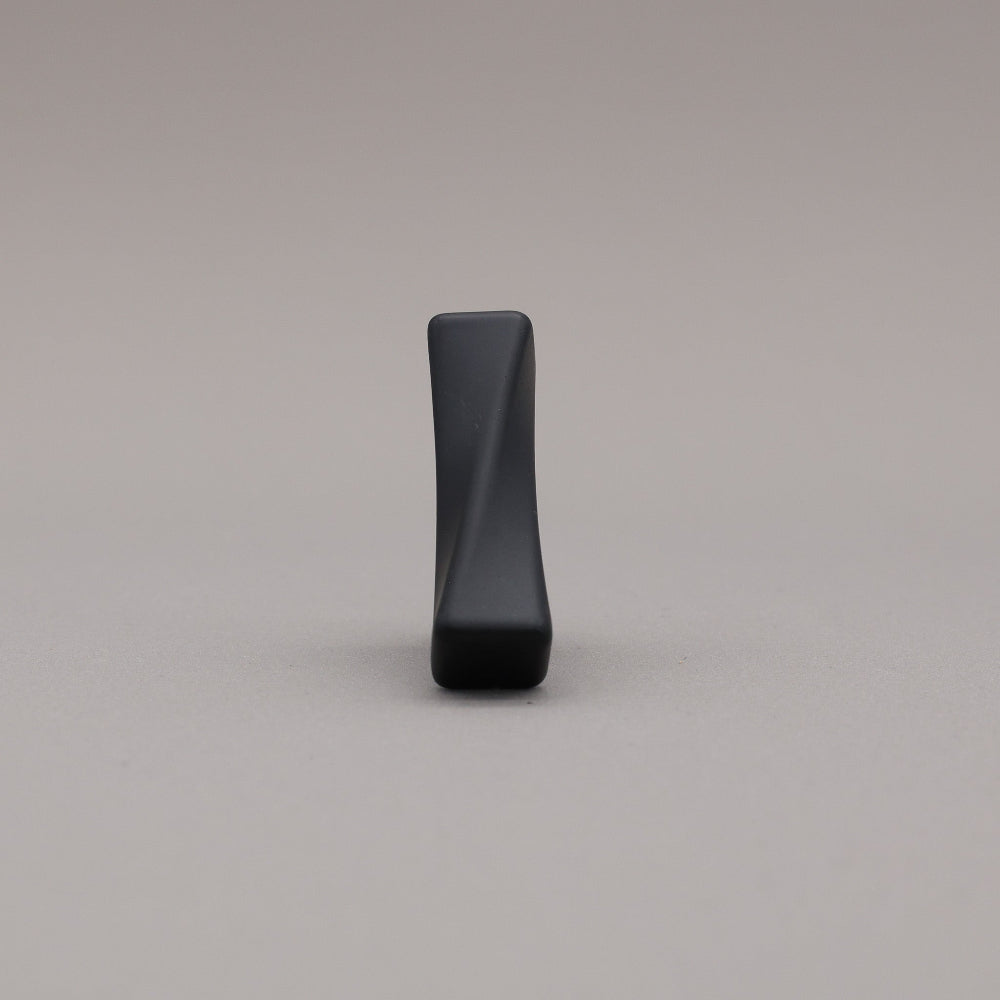 Black twisted knob on a beige background