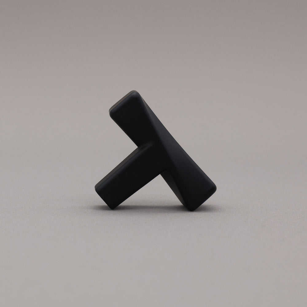 Black abstract sculpture on a gray background