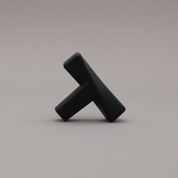 Black abstract sculpture on a gray background