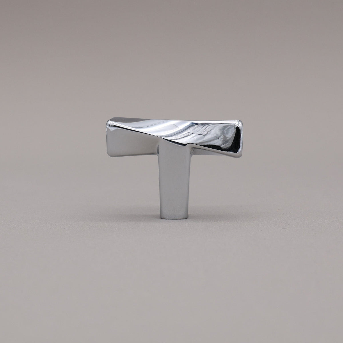 Polished Chrome Knob on a gray background.