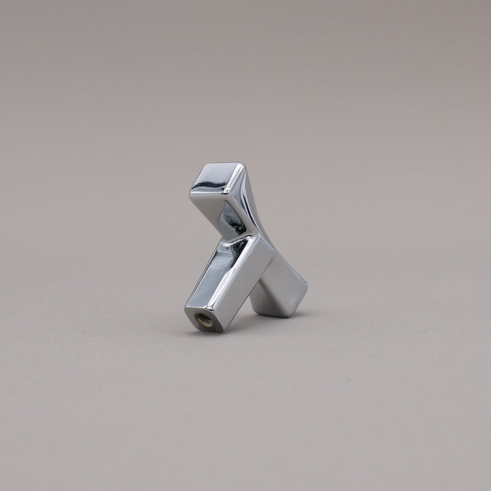 Metallic twist pollished chrome object on a gray background