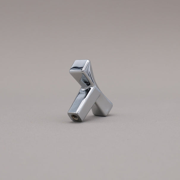 Metallic twist pollished chrome object on a gray background