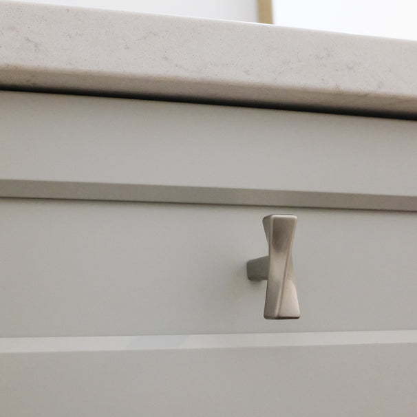 Twist Knob in Satin Nickel on Gray Cabinet Drawers.