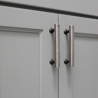 Cabinet pull that is two tone with black and weathered nickel.