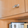 Clarity T-Knob in a Clear Acrylic and Satin Nickel finish installed on a brown cabinet door