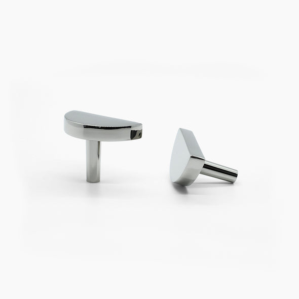 Two Polished Nickel Half Moon knobs, one standing and one side-facing while laying down