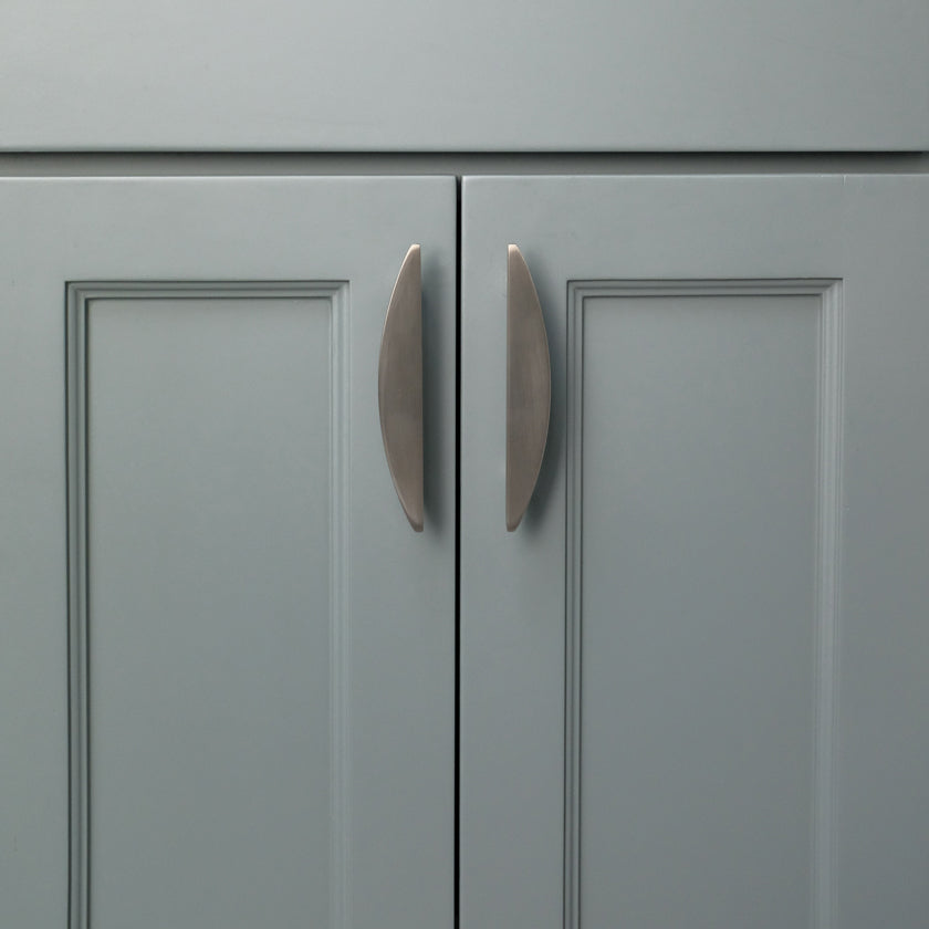 Two 4" Satin Nickel Half Moon cabinet pulls installed on blue cabinet doors 