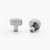 Two Polished Nickel Hapny Ribbed knobs, one standing and one rear-facing while laying down