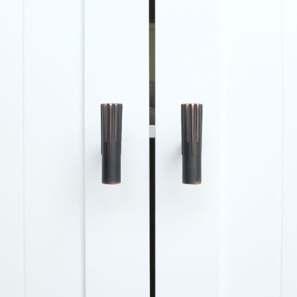 Two Hapny Sunburst t-knobs in a Venetian Bronze finish installed on white cabinet doors