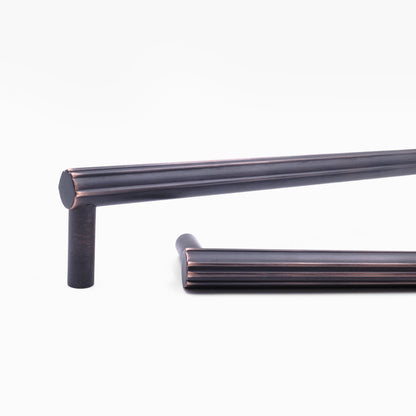 Close up view of design detailing on two Hapny Sunburst appliance pulls in a Venetian Bronze finish