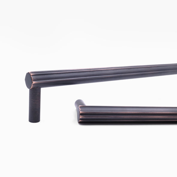 Close up view of design detailing on two Hapny Sunburst appliance pulls in a Venetian Bronze finish