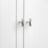 Two Polished Chrome Hapny Twist t-knobs installed on white cabinet doors