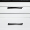 Black cabinet pulls horizontal on white kitchen drawers for a modern look