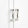 Two Polished Nickel Hapny Twist 96mm cabinet pulls installed on white cabinet doors