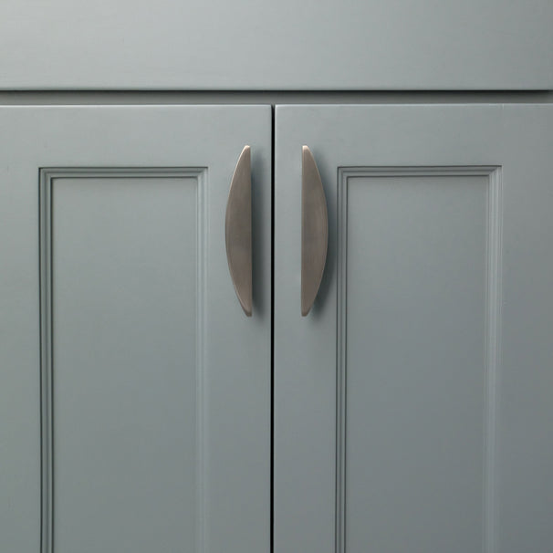 Two 4" Satin Nickel Half Moon cabinet pulls installed on blue bathroom cabinet doors.