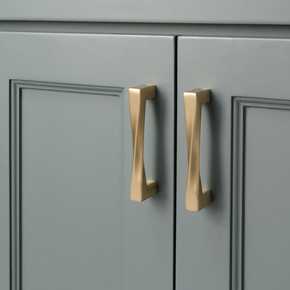 Twist cabinet pulls on bathroom vanity in satin brass in designer home